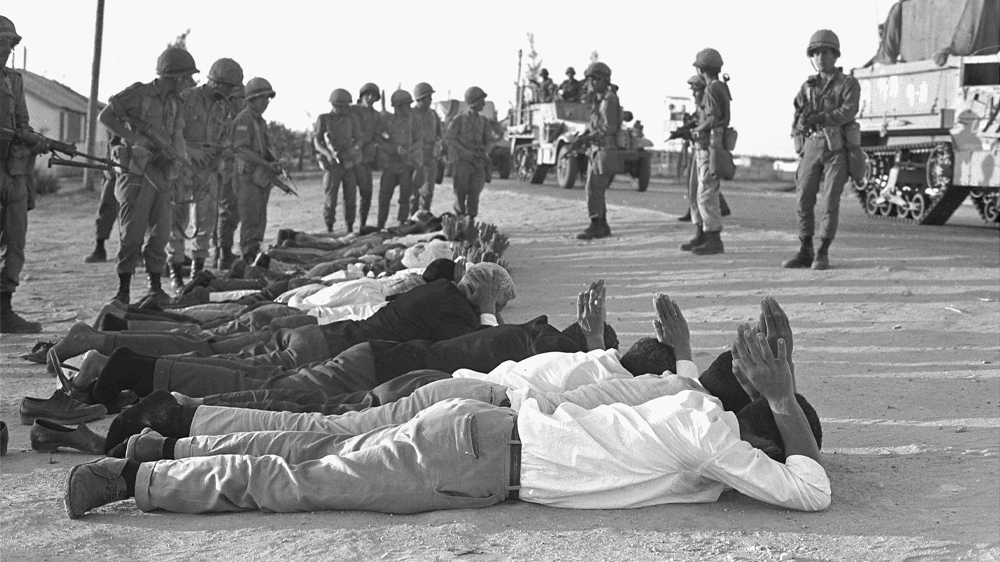 
Israeli soldiers stand over captured Egyptians and Palestinians at the start of the war on June 5, 1967 [Getty Images]
