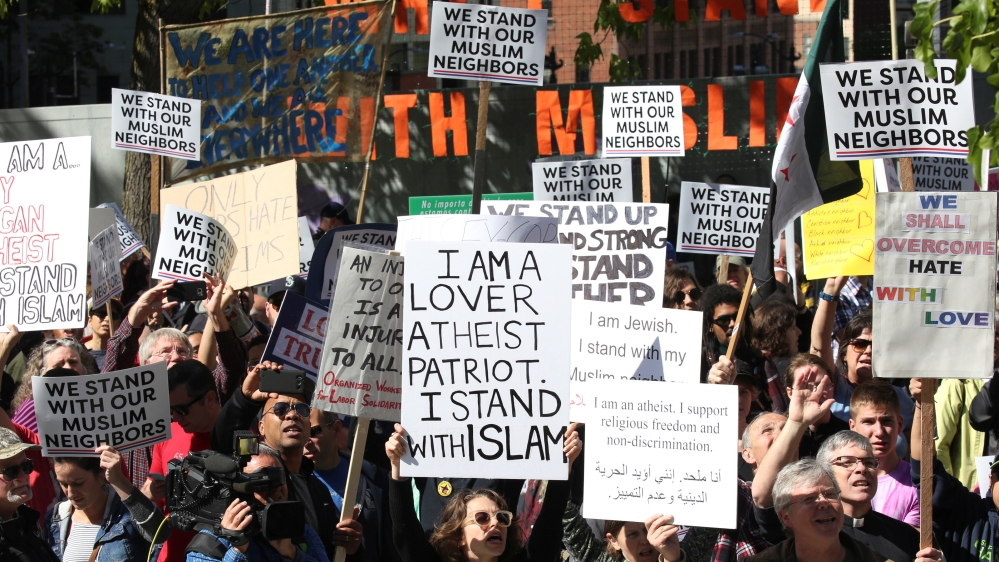 Counterprotesters hold signs and shout slogans during an anti-Sharia rally in Seattle, Washington, on June 10, 2017 [David Ryder/Reuters]