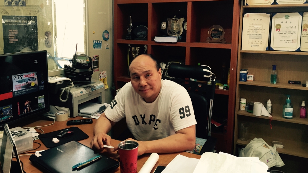 Assan's manager, Lee Kyoung-hoon, is a 54-year-old former boxer [Steven Borowiec/Al Jazeera]