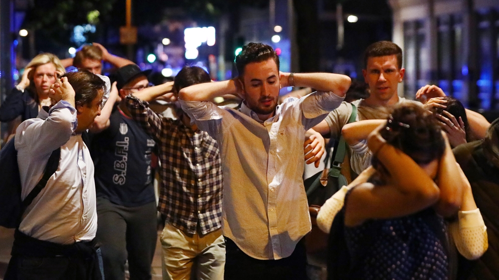 Police told pedestrians leaving the scene near the bridge to raise their hands over their heads as they exited the area [Reuters]