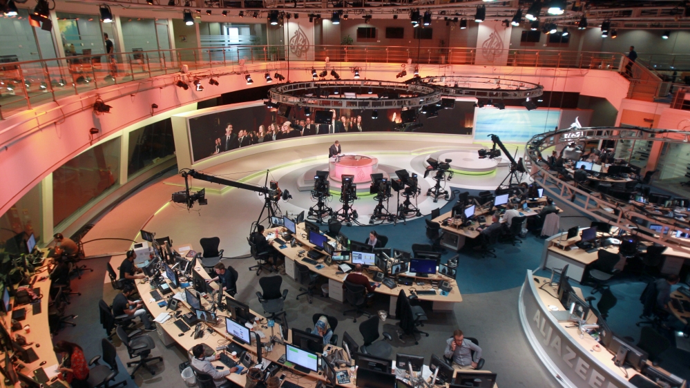 Staff work inside the Al Jazeera Network HQ in Doha