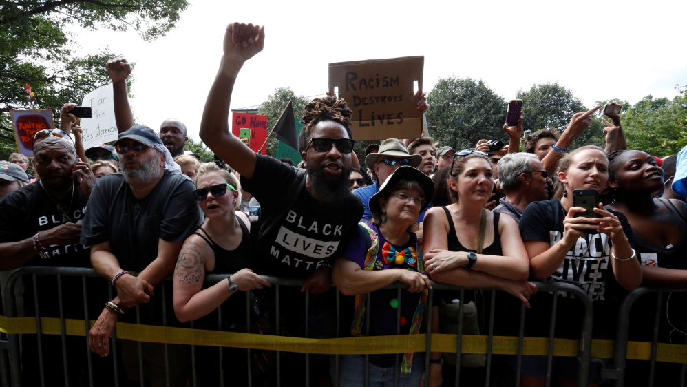 Hundreds of jeering protesters denounced racism at the KKK rally in Charlottesville [Jonathan Ernst/Reuters]