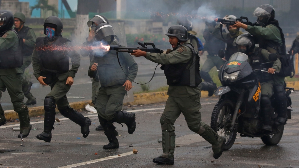 Riot security forces take up positions while clashing with demonstrators rallying against Venezuela''s President Nicolas Maduro''s government in Caracas