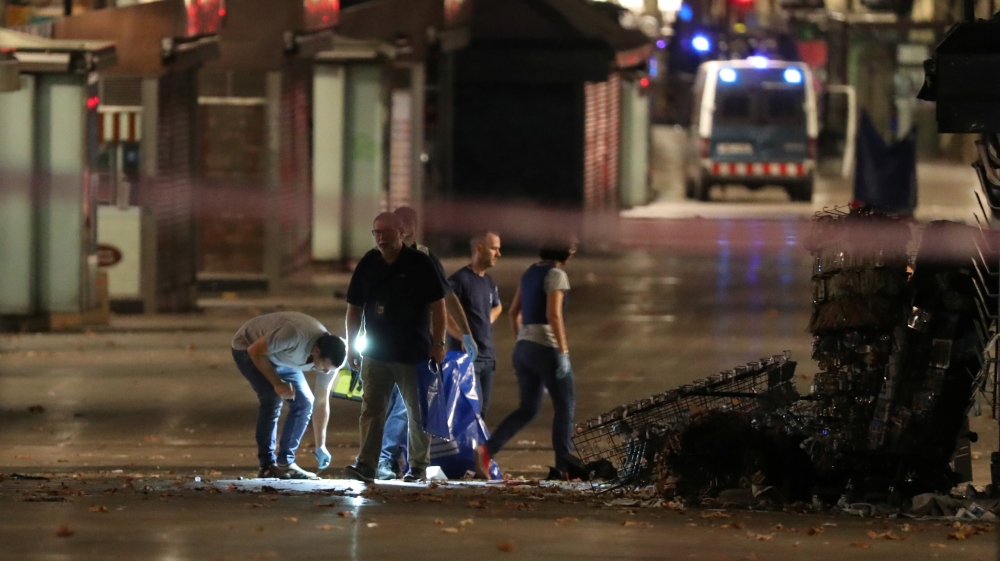 Forensic police search for clues near area where a van crashed into pedestrians at Las Ramblas, Barcelona [Sergio Perez/Reuters]