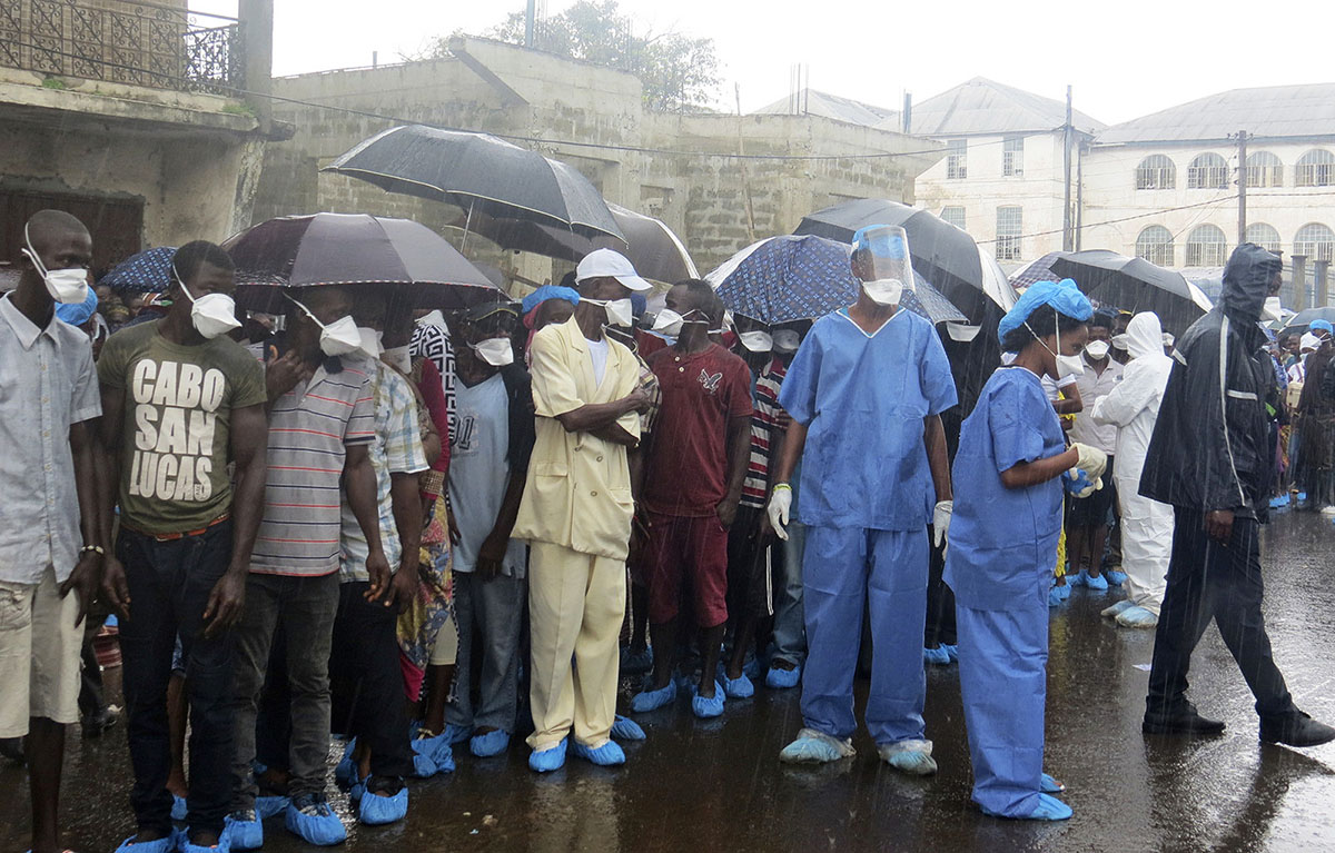 Family of victims of heavy flooding and mudslides in Regent wait to identify their bodies at Connaught hospital morgue in Sierra Leone, Freetown, Wednesday, Aug. 16 , 2017. Family members line up in