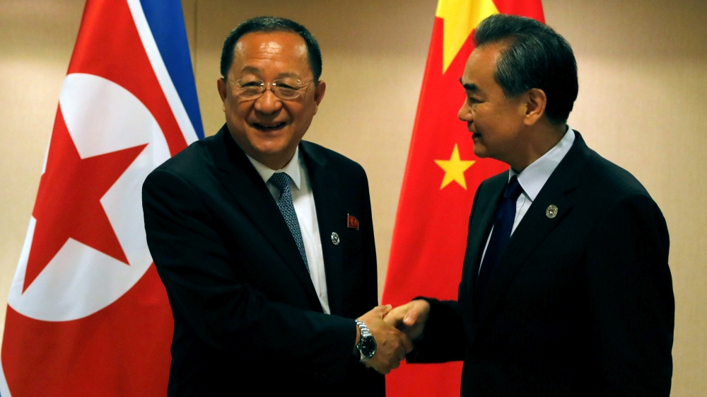 China''s Foreign Minister Wang Yi shakes hands with North Korea''s Foreign Minister Ri Yong Ho before their bilateral meeting on the sidelines of the 50th ASEAN ARF in Manila