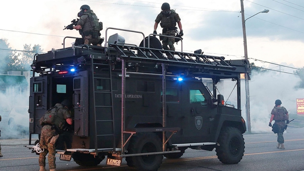 St. Louis County tactical police officers fired tear gas to disperse protesters after a police officer shot and killed unarmed 18-year-old Michael Brown in Ferguson, August 2014 [File: Robert Cohen /St. Louis Post-Dispatch/EPA]