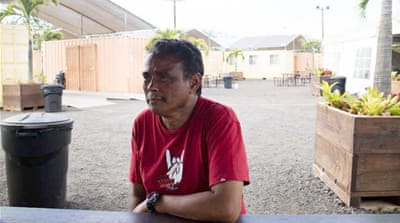Castillo sits in the shelter run by IHS in Oahu [Emre Caylak/Al Jazeera]