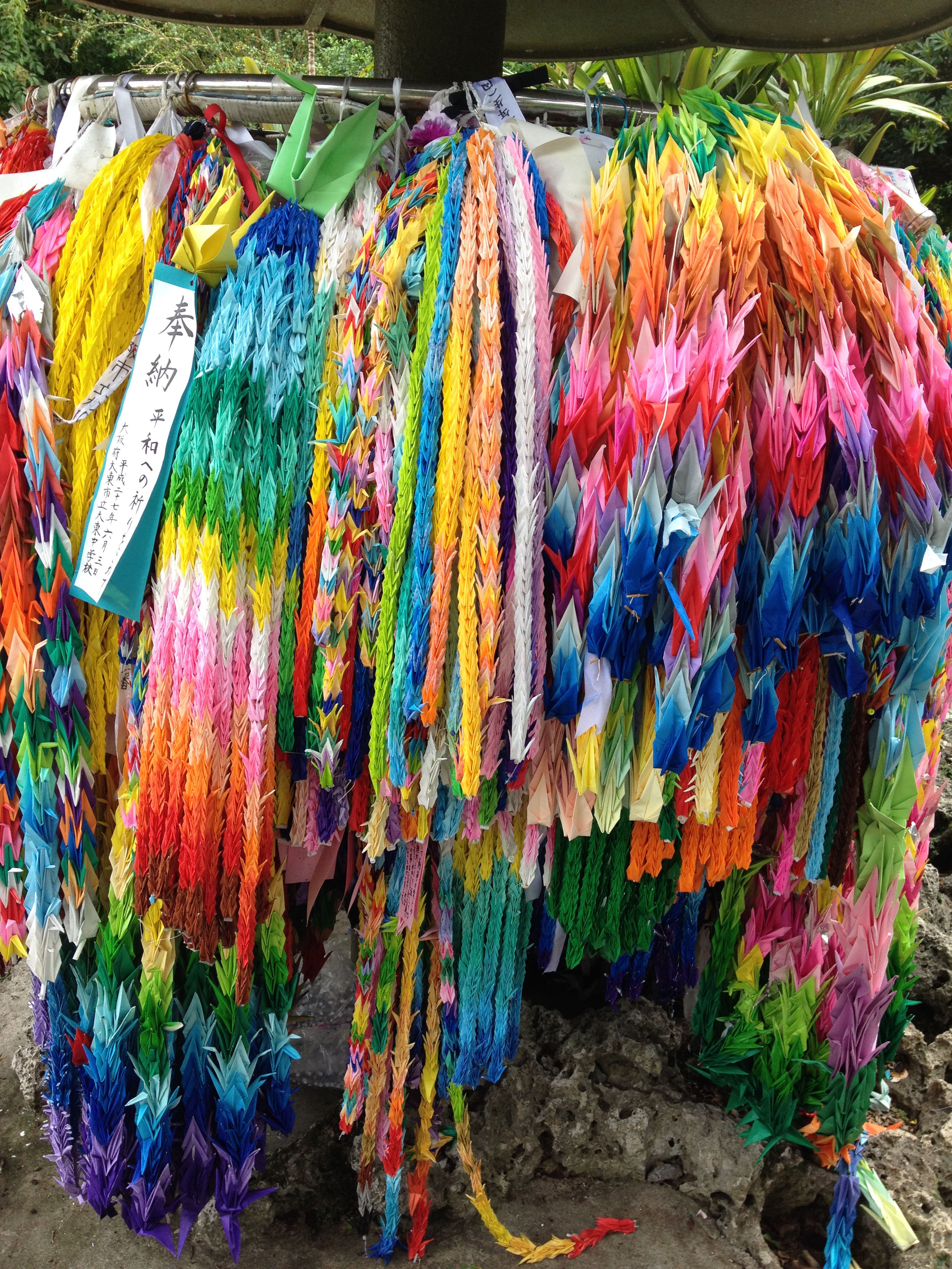Tens of thousands of colorful origami folded paper cranes hang on a memorial at the Himeyuri Peace Museum honouring students who were killed in the Battle of Okinawa in 1945. The bitter memories of war have fuelled a passionate anti-military sentiment on this island in southernmost Japan. Photograph taken in June, 2015 [Jon Letman/Al Jazeera]