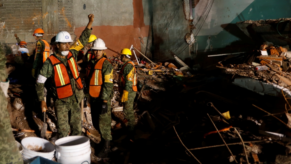 Soldiers gesture for silence as they search for survivors in Mexico City [Carlos Jasso/Reuters]