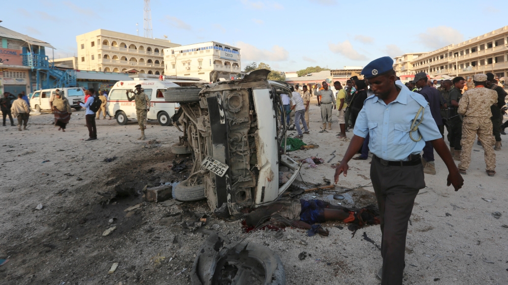Somali security officers secure the scene of a car explosion in Hamarweyne district of Mogadishu