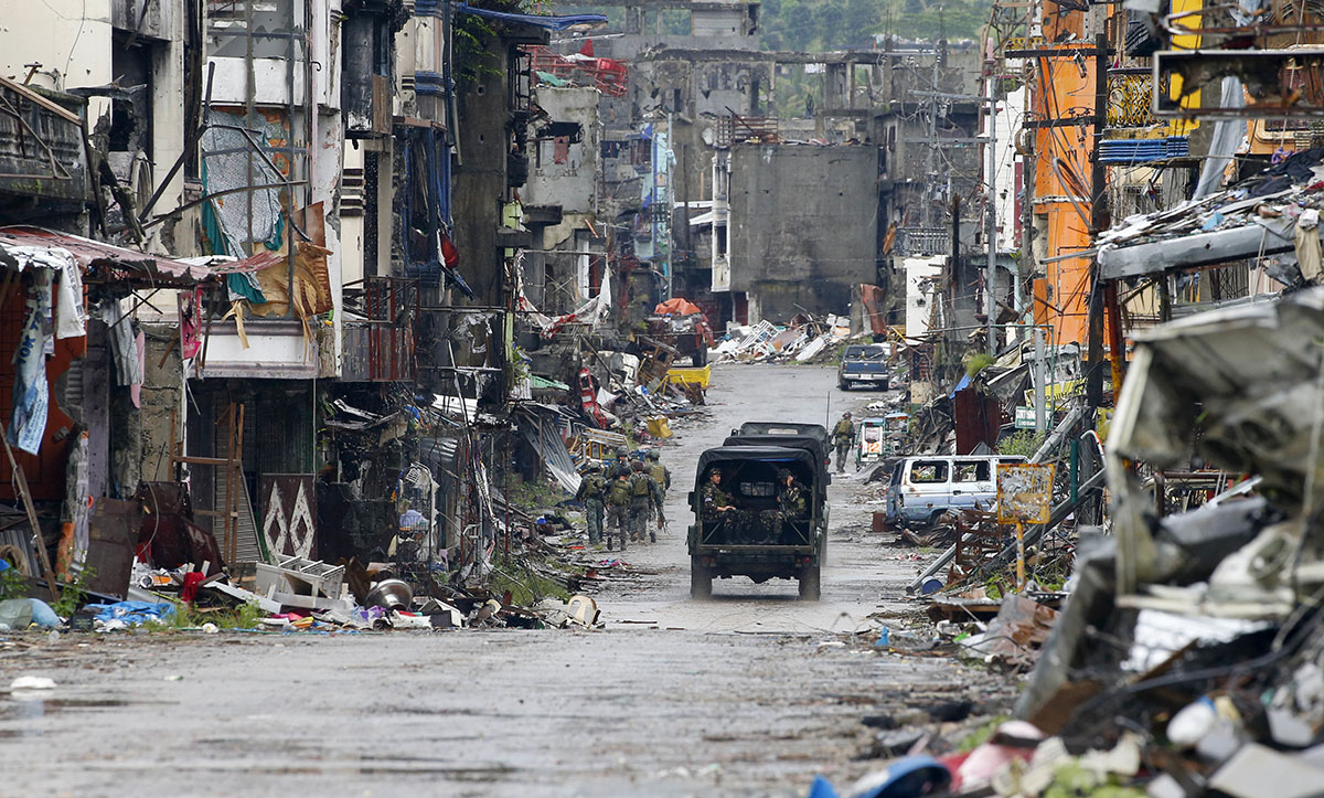 In thisTuesday, Oct. 17, 2017, file photo, Philippine troops return to their deployment after attending the ceremony where President Rodrigo Duterte declared the liberation of Marawi city in southern