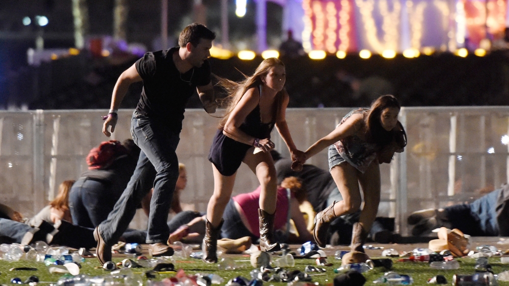 People run after hearing gun fire at the the Route 91 Harvest country music festival [David Becker/Getty Images] 