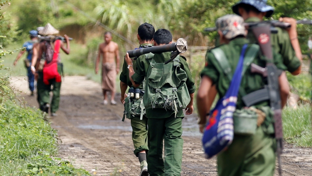 Myanmar soldiers patrol a road in Maungdaw