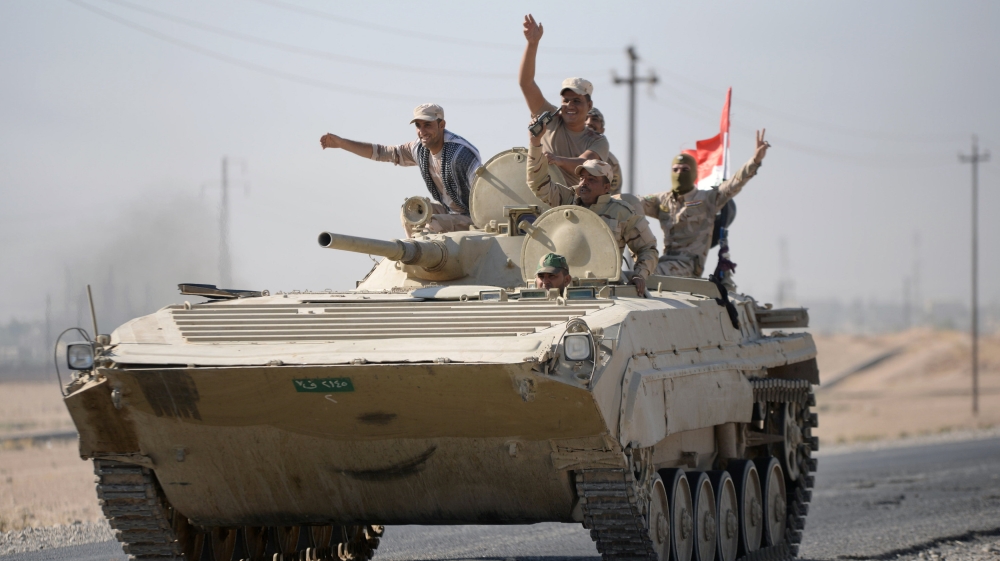 Iraqi army members advance in military vehicles in Kirkuk