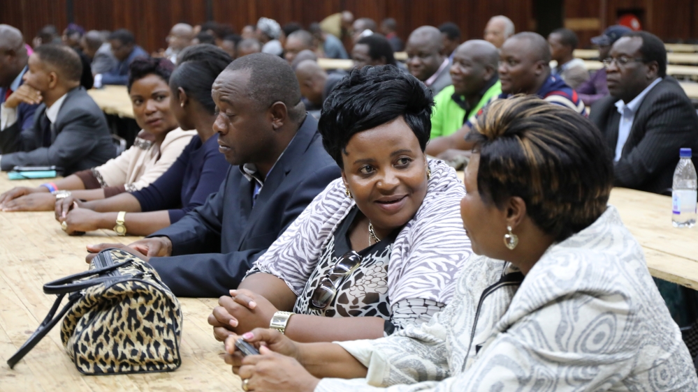 ZANU-PF MPs chat at their party headquarters ahead of discussions on the possible impeachment of President Robert Mugabe in Harare