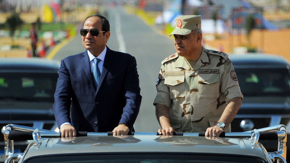 Egyptian President Abdel Fattah al-Sisi rides a vehicle with Egypt''s Minister of Defense Sedki Sobhi during a presentation of combat efficiency and equipment of the armed forces in Suez