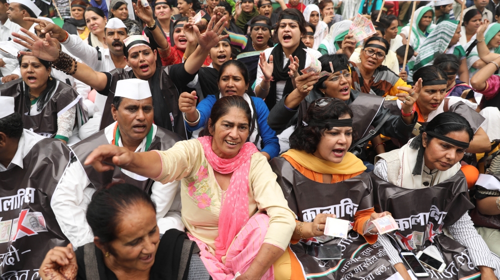 
India's main opposition Congress party supporters shout slogans during a protest on the first anniversary of the demonetization announcement, in New Delhi, India [Supreet Jayanna/Al Jazeera]
