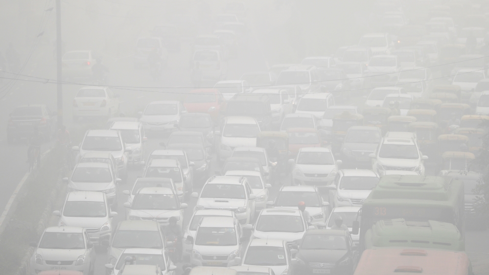 Vehicles drive through heavy smog in Delhi
