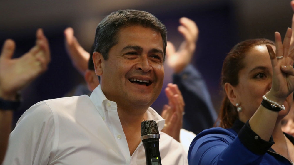 Hernandez celebrates with supporters after the first official presidential election results were released in Tegucigalpa [Edgard Garrido/Reuters]