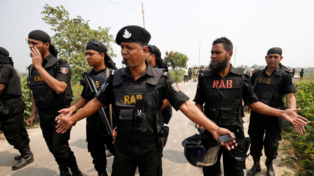 Security personnel block the road where police shot dead a suspected militant who tried to enter a security checkpost on a motorcycle armed with explosives in Khilgaon,