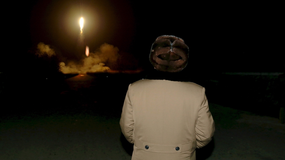 Kim watching missiles Reuters
