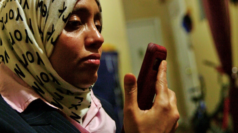 Khulood Nasher speaks with her son, Rami, who is still in Yemen [Mallory Moench/Al Jazeera]