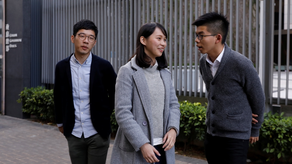 Chow [centre] sought to fill the council seat of Nathan Law [left] who was stripped of his position for his role in the pro-democracy movement [File: Reuters]