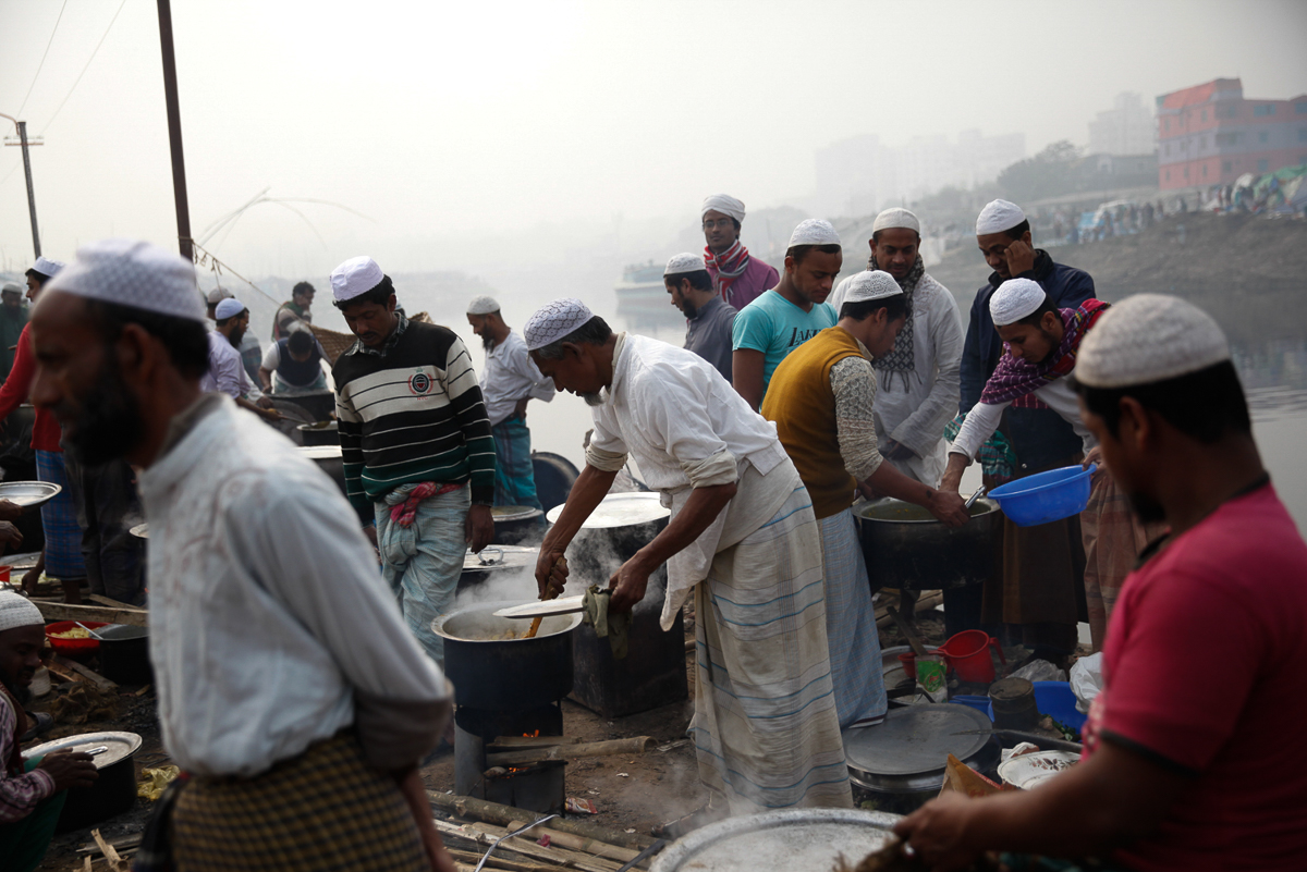 Mohammad Anis Hossain(middle) with his friends prepare meals five times a day. “I am luck that I get a chance to serve my brothers with good food” said Mohammad. [Mahmud Hossain Opu/Al Jazeera]