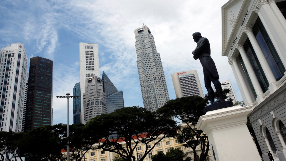 A statue of Sir Stamford Raffles stands next to the Victoria Theatre in the Central Business District of Singapore [Reuters/Edgar Su]