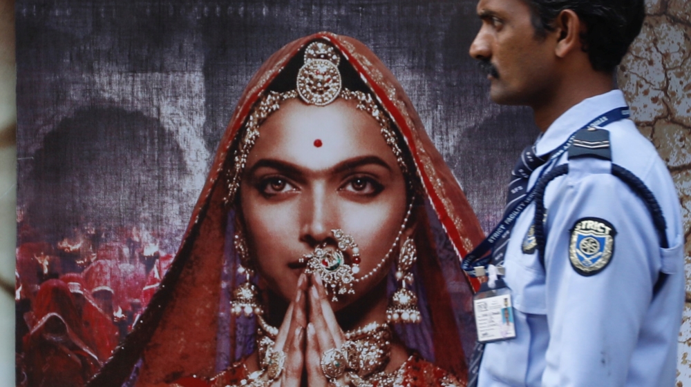 A security guard walks past a poster of the upcoming Bollywood movie ''Padmavati'' outside a theatre in Mumbai