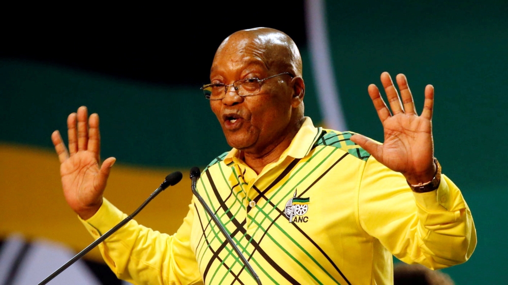 ILE PHOTO: President of South Africa Jacob Zuma gestures to his supporters at the 54th National Conference of the ruling ANC at the Nasrec Expo Centre in Johannesburg