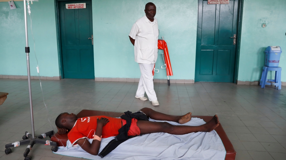A protester, who was shot in the leg by police during a protest, lies in a hospital in Kinshasa