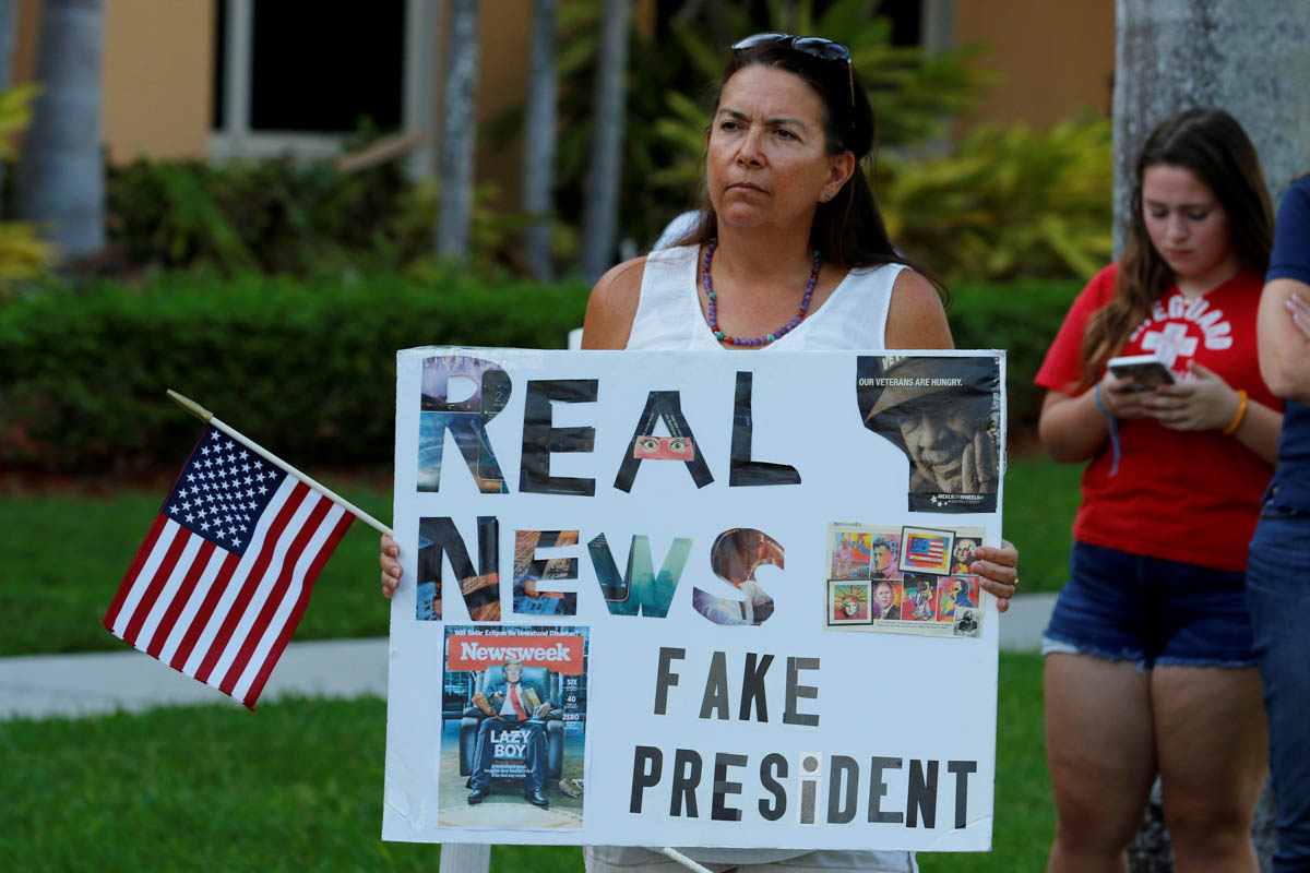 A protester holds a sign at a Call To Action Against Gun Violence rally by the Interfaith Justice League and others in Delray Beach, Florida, U.S. February 19, 2018. REUTERS/Joe Skipper TPX IMAGES OF