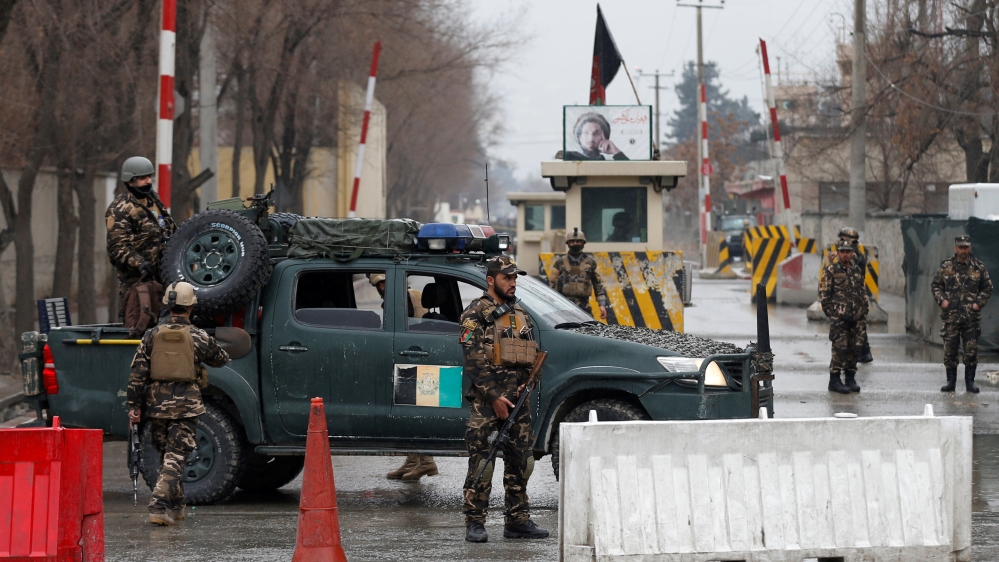 Afghan security forces keep watch at a check point near the site of a suicide attack in Kabul