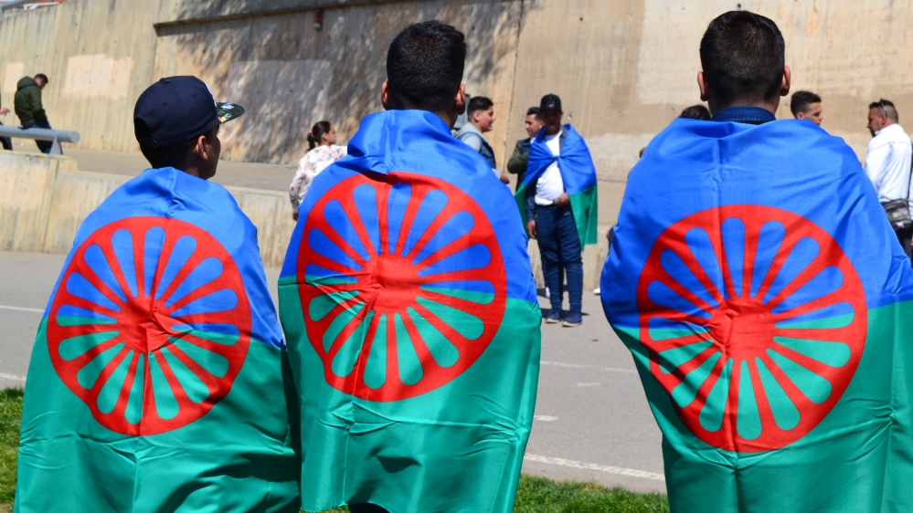 Roma boys wear the international flag of Roma in Barcelona [Brietta Hague/Al Jazeera]