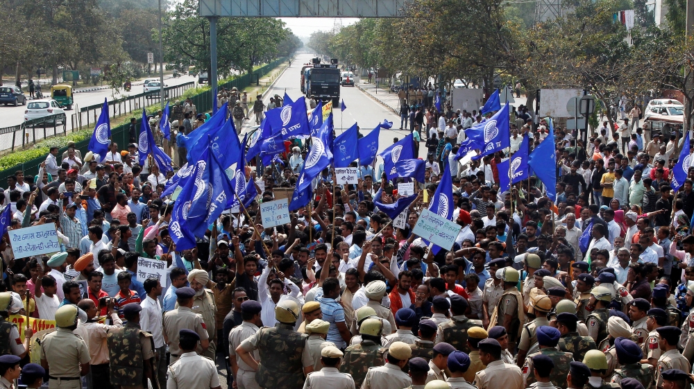 Police try to stop people belonging to the Dalit community as they take part in a protest in Chandigarh, Punajb state [Ajay Verma/Reuters]