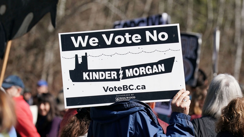 A protester listens to speeches at a protest rally against Morgan's Trans Mountain pipeline in southern British Columbia [File: Nick Didlick/Reuters]