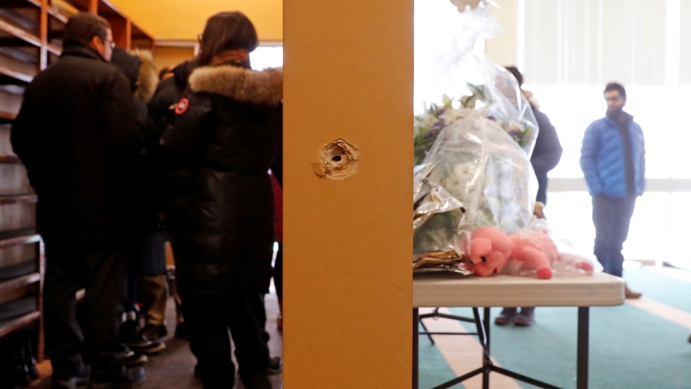 A bullet hole is pictured at the Quebec Islamic Cultural Centre in Quebec City, February 1, 2017. [Mathieu Belanger/Reuters]