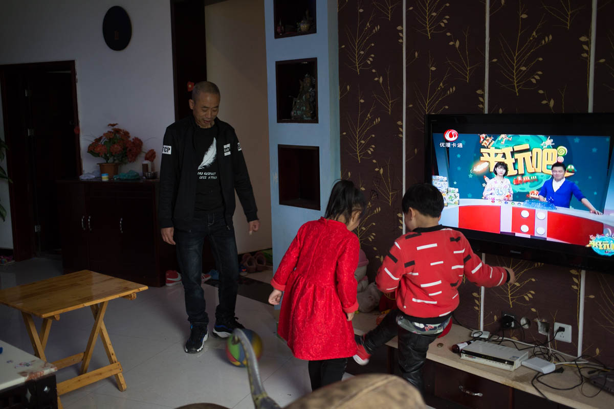 Zhao plays ball game with his son and daughter. Zhao it’s not easy to play games like that for a man over 50, but he cherishes the time that he spends with the kids.