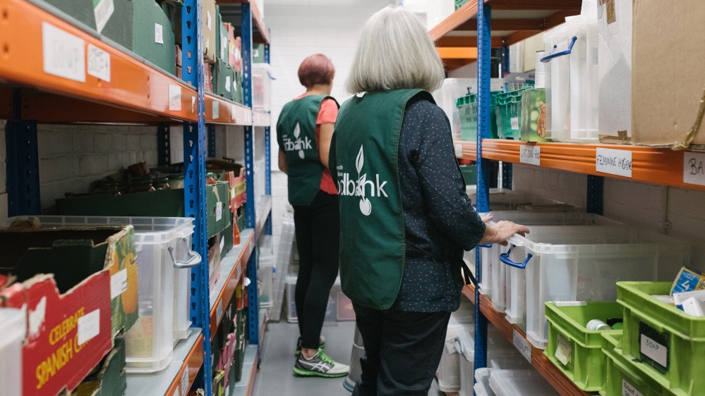  Volunteer staff select ingredients for each foodbank clients' picking list in The Hub’s store room [James Rippingale/Al Jazeera] Volunteer staff select ingredients for each foodbank clients' picking list in The Hub’s store room [James Rippingale/Al Jazeera]