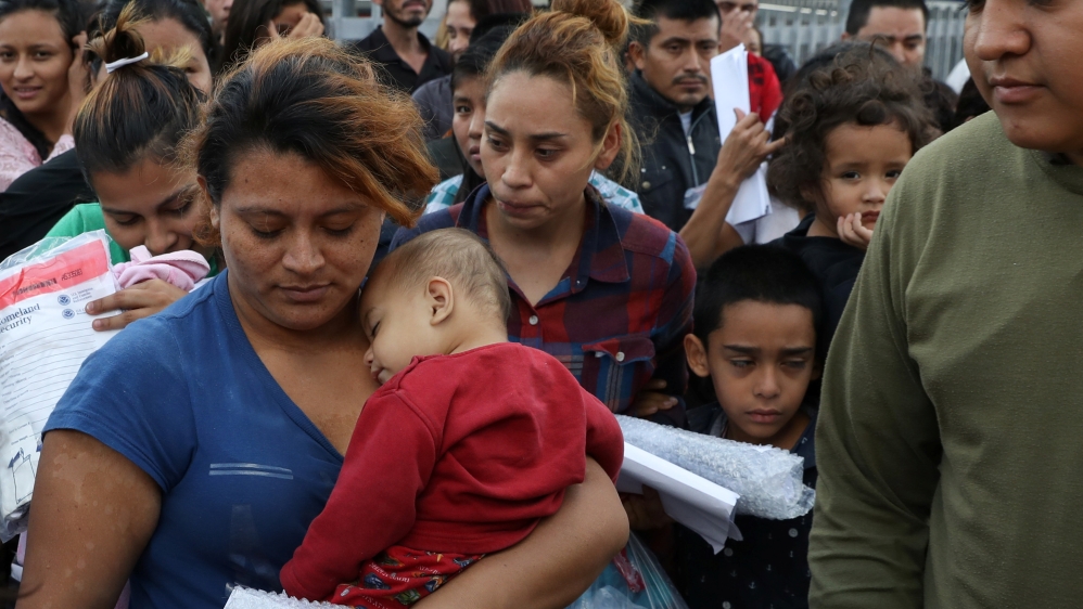 Undocumented immigrant families are released from detention at a bus depot in McAllen, Texas [Loren Elliott/Reuters] 