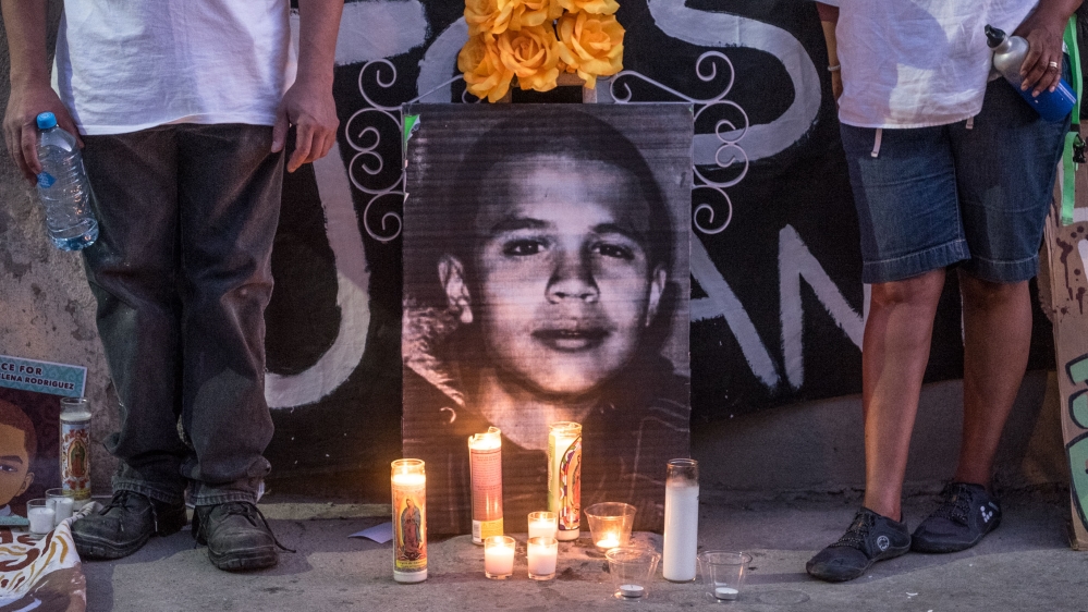 Candles and a picture of José Rodriguez during a vigil. [Eline van Nes/Al Jazeera]
