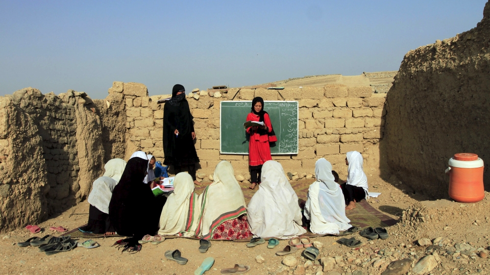 Afghan girls study at an open area,