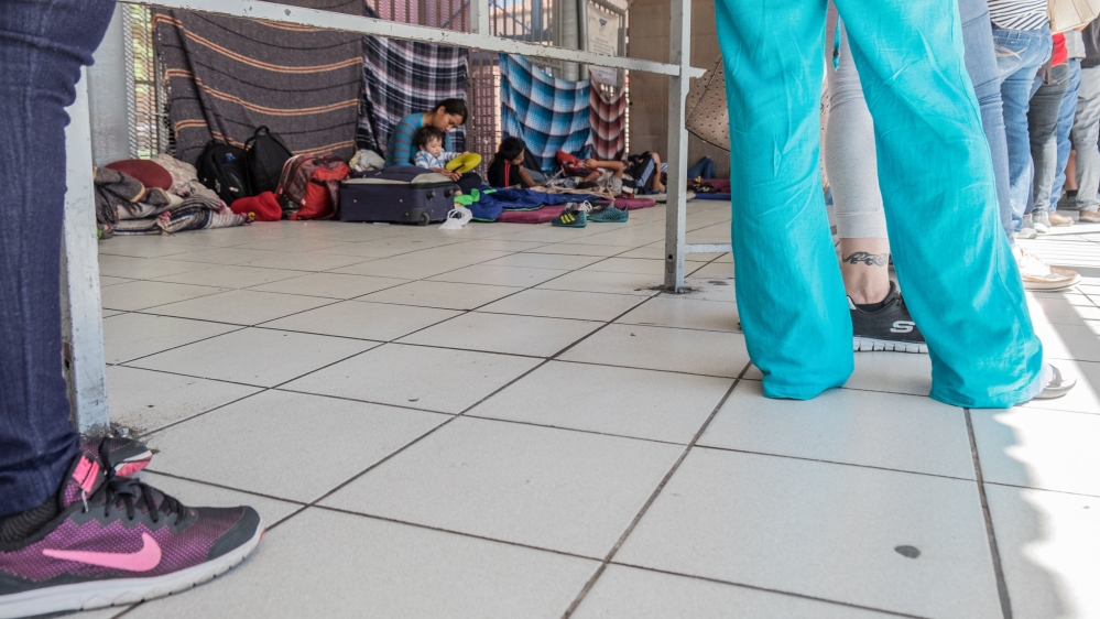 While people stand in line for no more than a few minutes to have their passports or IDs checked, Carina Varera Gutierrez waits. [Eline van Nes/Al Jazeera]