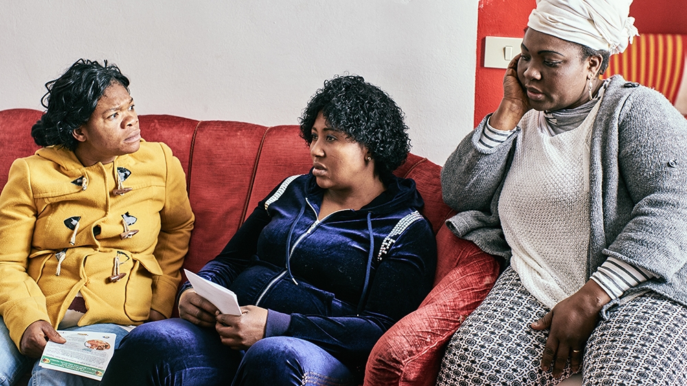 Mercy, left, works for Women of Benin and supports trafficking victims in Italy [Naomi Morello/Al Jazeera]