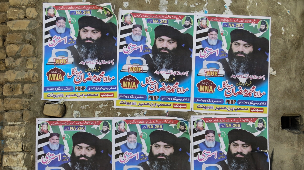 Ramzan Mengal's election posters carry a picture of himself, as well as of ASWJ chief Ahmed Ludhianvi (top left). He is fighting under the election symbol of an