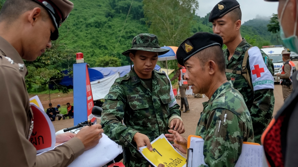 
Journalists and non-essential staff are ordered to leave the cave site and surrounding roads at the start of the rescue operation on Sunday [Linh Pham/Getty Images]
