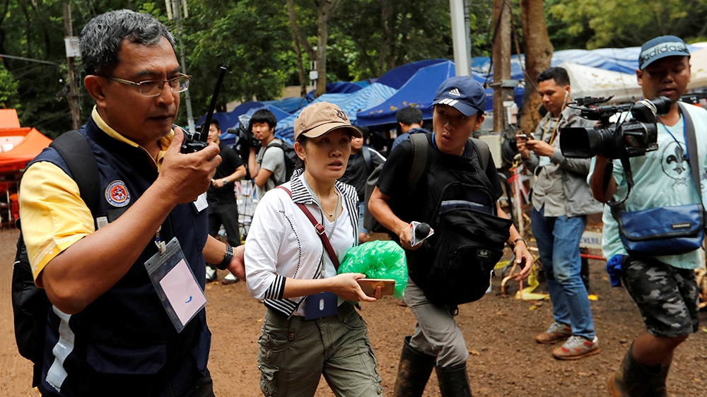 A family member walks outside the Tham Luang cave complex after Thailand's government instructed members of the media to move out urgently [Tyrone Siu/Reuters]