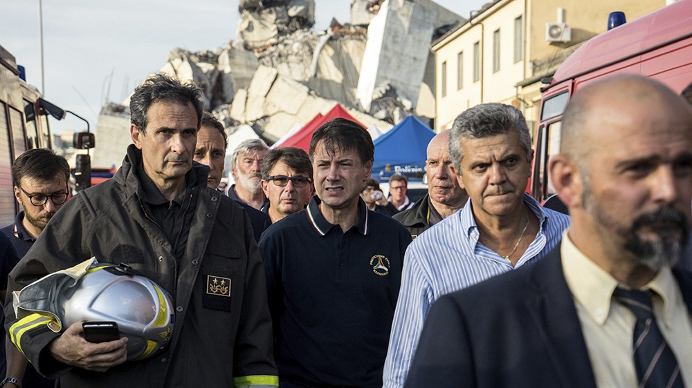Prime Minister Giuseppe Conte, centre, visits the site [Federico Scoppa/AFP]